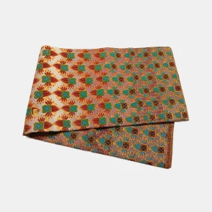 Folded Jewel of the Savannah Ankara fabric in vibrant orange, teal, and gold, featuring an abstract floral pattern on 100% cotton.