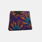 Folded Royal Indigo Bloom Ankara fabric featuring deep purple background and explosive blue and yellow floral prints.