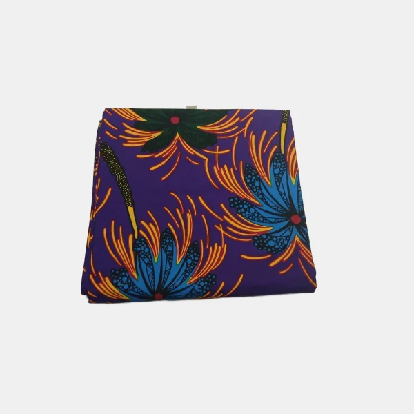 Folded Royal Indigo Bloom Ankara fabric featuring deep purple background and explosive blue and yellow floral prints.