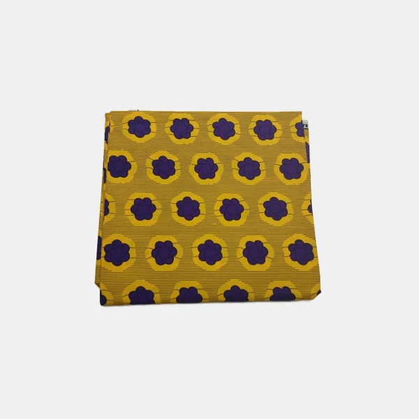 Folded Royal Sunset Blooms Ankara fabric with bright yellow and deep purple floral print on a striped background.
