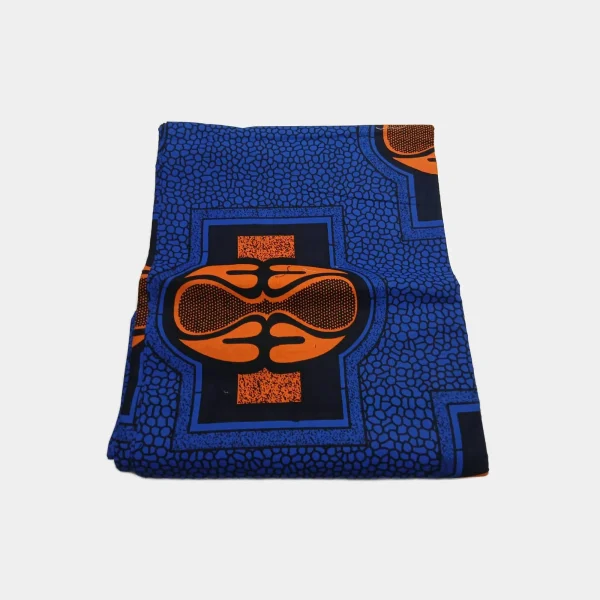 Folded Firefly Empress Jewel Luxury Ankara fabric in cobalt blue, navy, and vibrant orange wax print. 100% cotton.