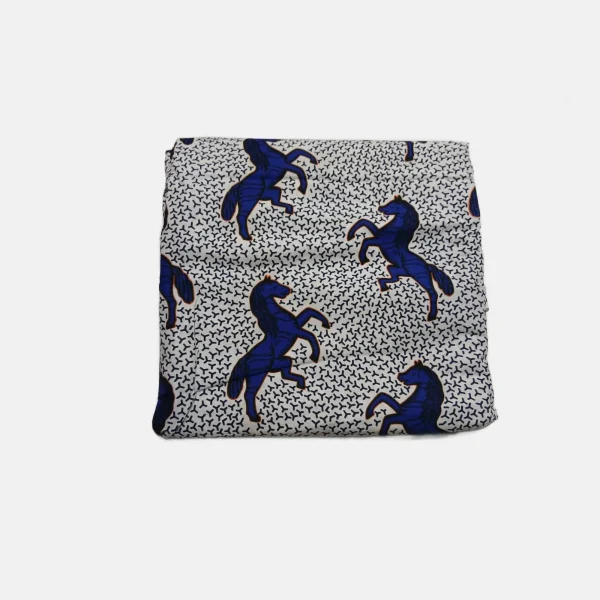 Folded White Storm Charger Ankara fabric featuring large royal blue rearing horses on a geometric white background.