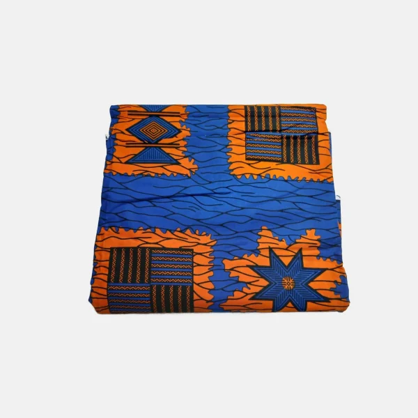 Folded Tidal Blaze Luxury Ankara fabric featuring deep blue waves and bright orange geometric star patterns.
