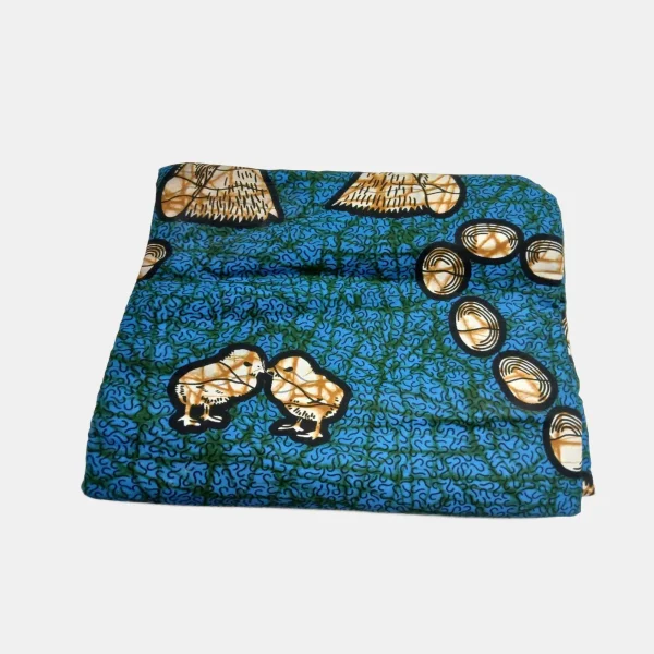 Folded 6-yard Golden Hatchlings Ankara fabric showing chicks and eggs in golden tan against a teal and blue 100% cotton background.